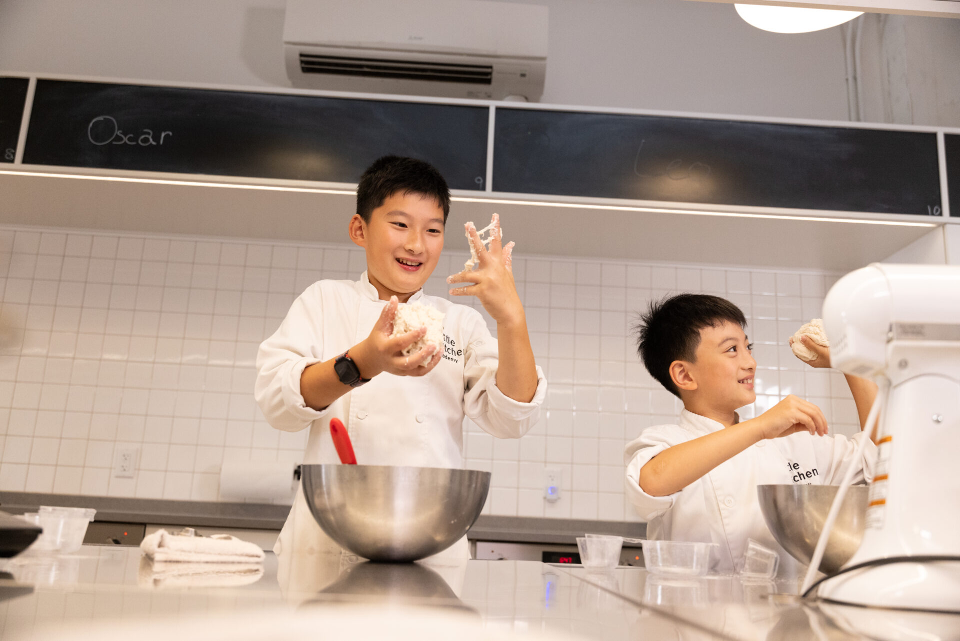 Two students making foccacia dough