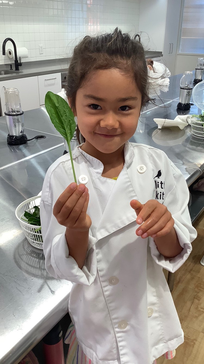 LKA student holding spinach