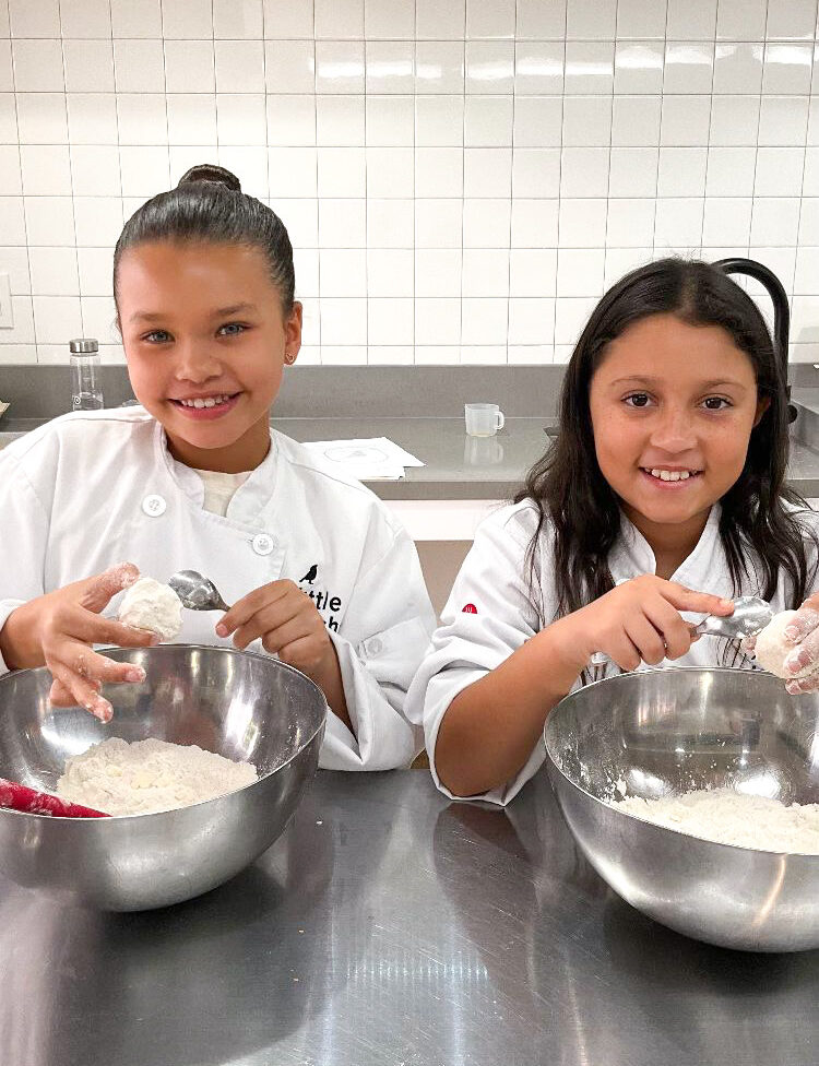 Two Little Kitchen Academy students measuring