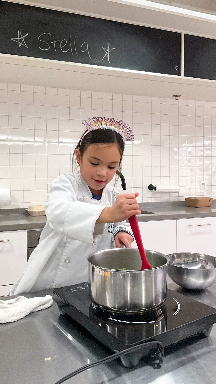 LKA Student Stirring Pot Wearing Birthday Hat