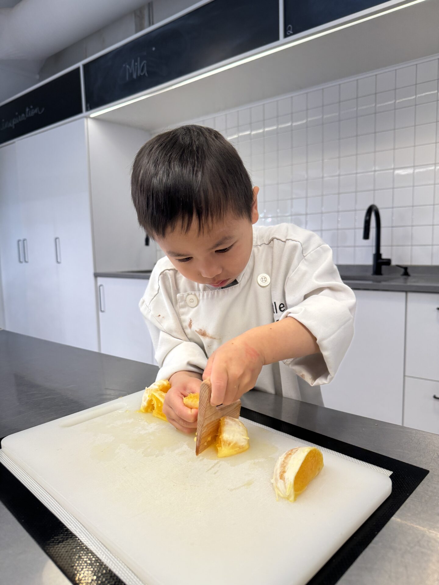 Student chopping oranges