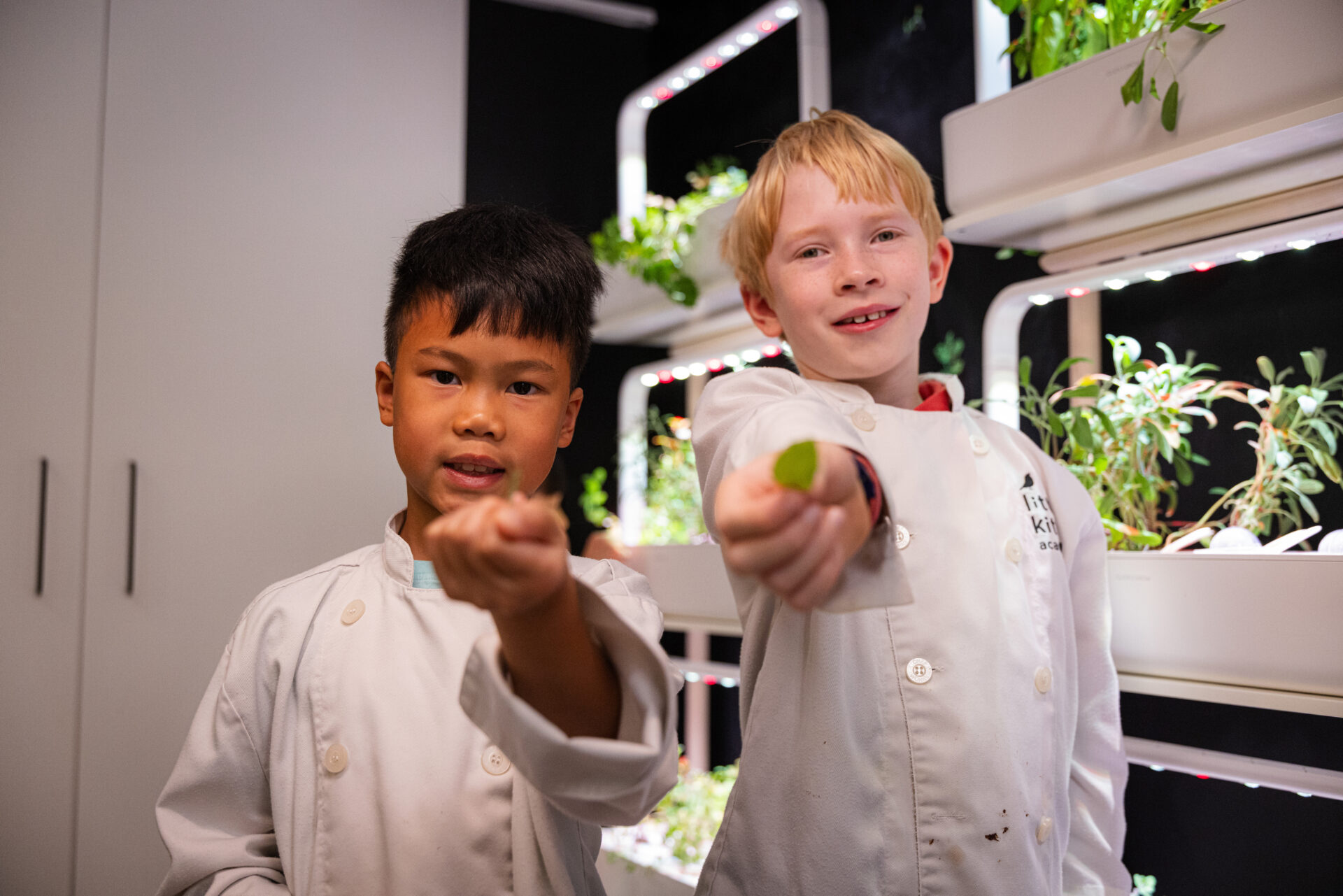 LKA students holding herbs from the living food wall