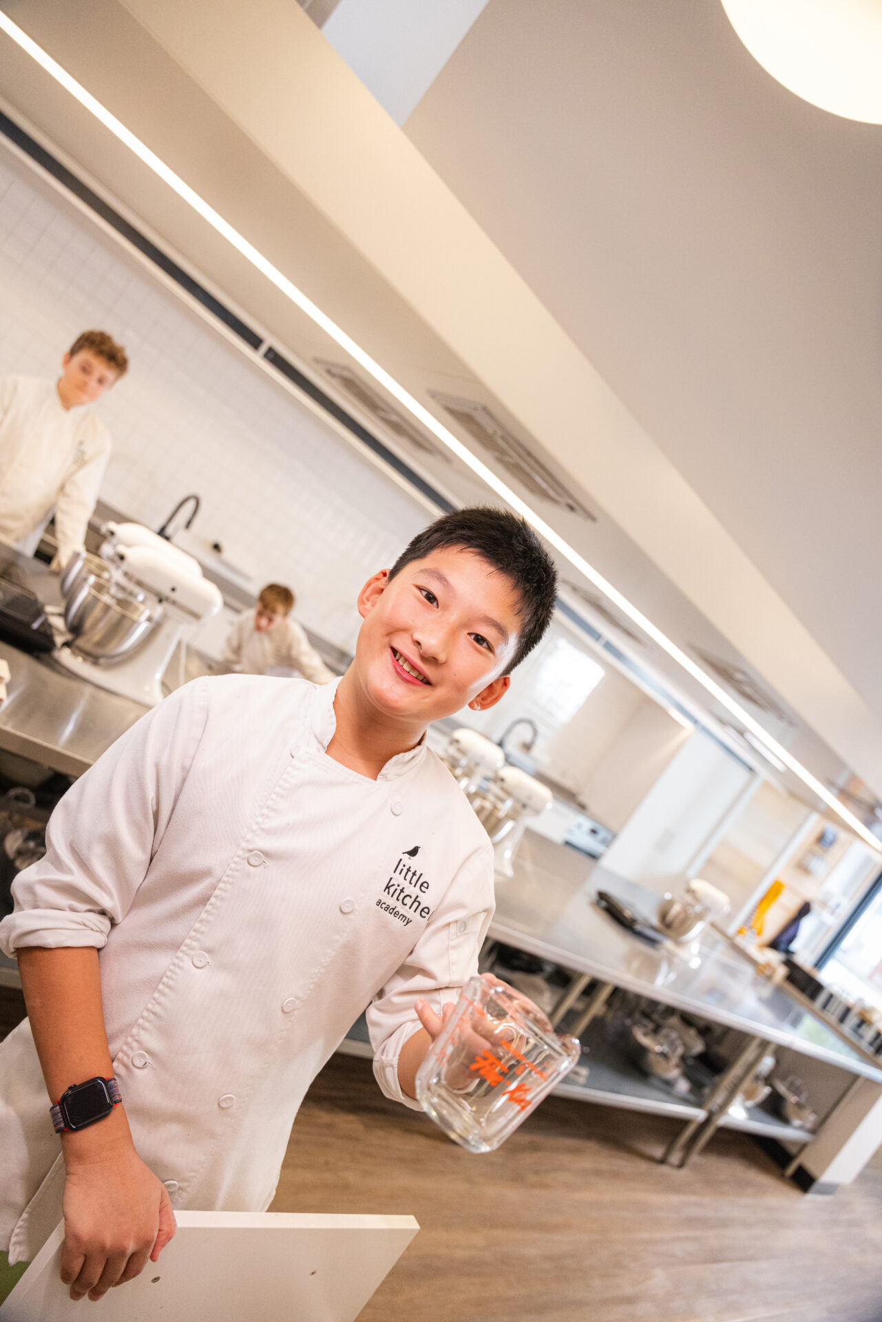 LKA student holding a measuring cup